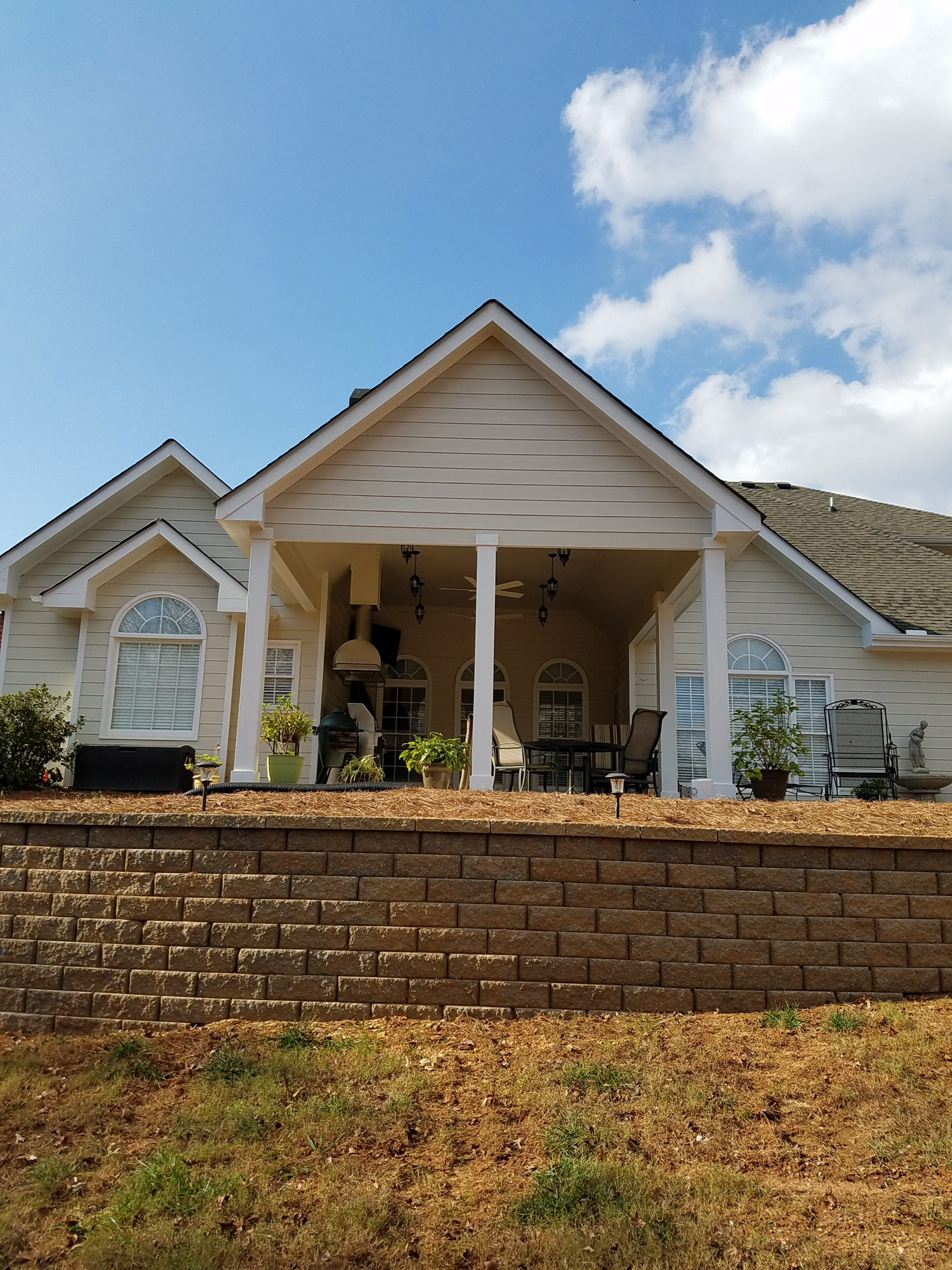 Covered porch exterior with block retaining wall — Keystone South Construction Georgia